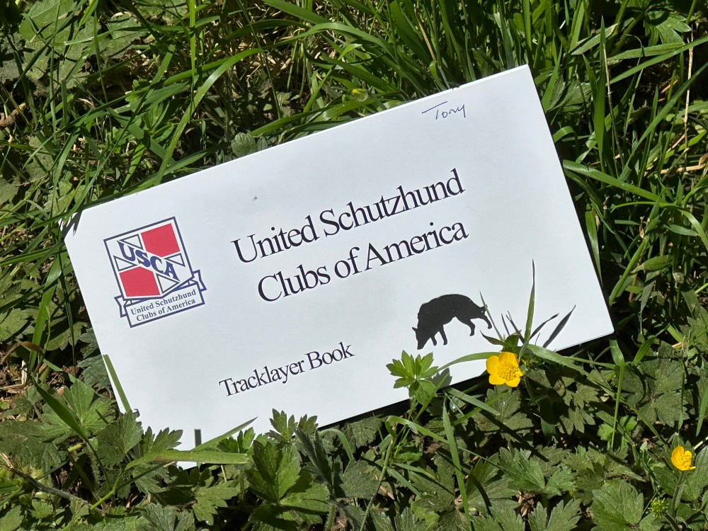 A USCA Tracklayer book lies in the grass